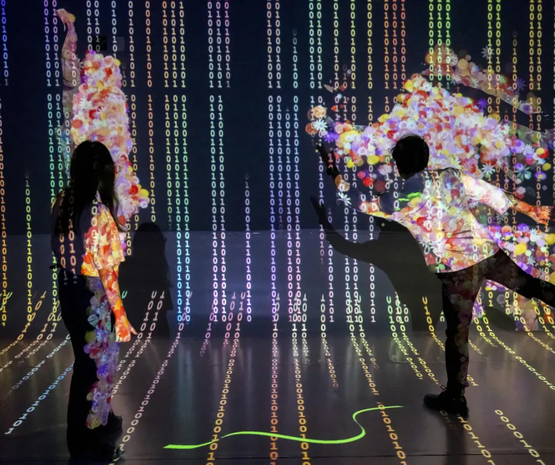 People in room moving. Binary numbers in colorful lights on walls