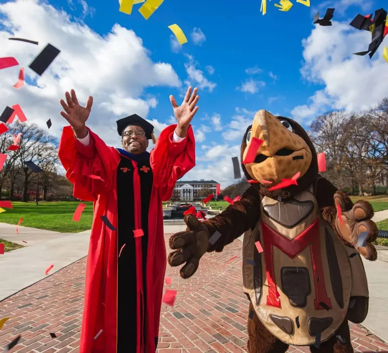 Dr. Pines and Testudo celebrating commencement
