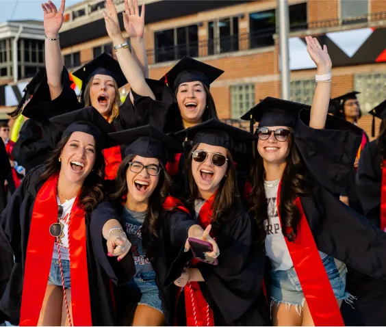 Smiling graduates in regalia