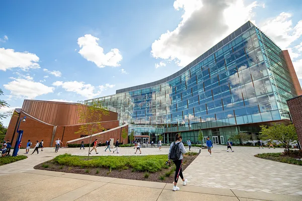 Modern building with students walking around outside