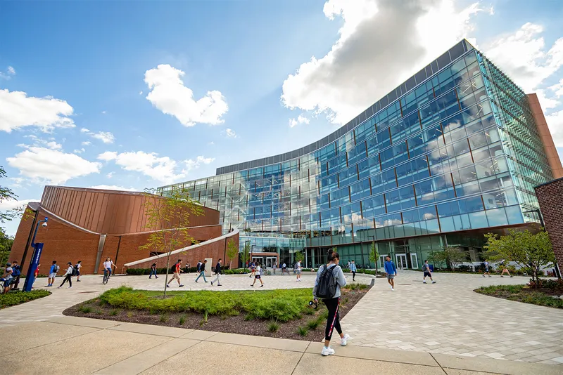 Modern building with students walking around outside